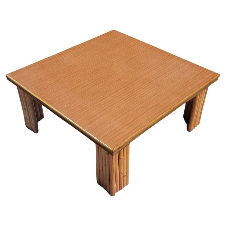 Restored 3' Foot Wide Rattan Coffee Table W/ Formica Top: Extra wide 36" square coffee table with 9-strand vertically stacked rattan legs and a Formica wood grain pattern top with a rattan trim along the borders. 1950, United States We only purchase and