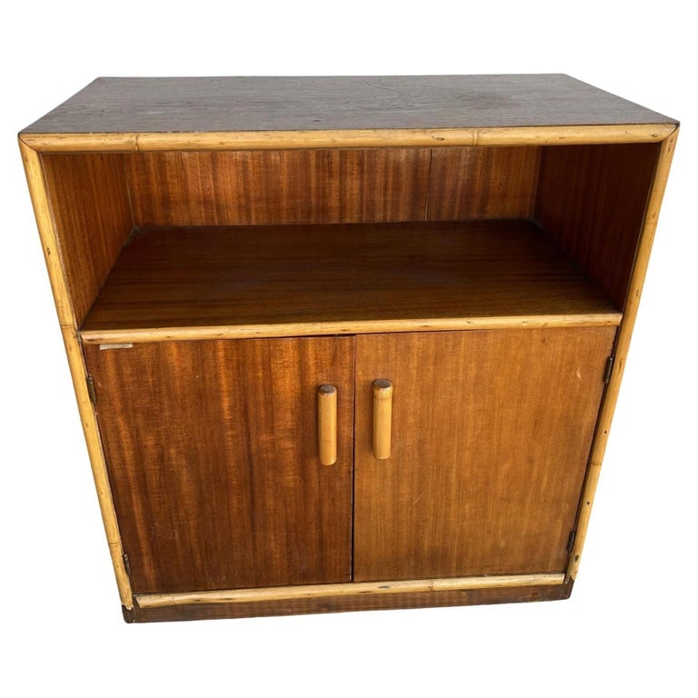 Restored Mahogany & Rattan Cabinet W/ Cubby Space: Restored Post War Mahogany Cabinet with Rattan Accents featuring a rattan trim with single shelf cubby space and a 2-door cabinet underneath which opens to two fixed shelves. 1940, United States We on