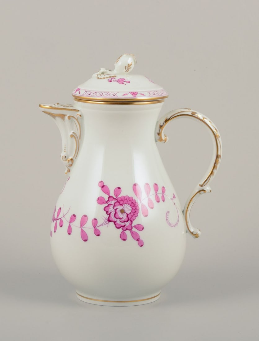 Meissen, Germany. "Pink Indian" porcelain coffee pot with purple floral motifs, gold rim. Mid-20th: Meissen, Germany. A "Pink Indian" porcelain coffee pot. Hand-painted with purple floral motifs, gold rim. Lid with flower bud in relief. Mid-20th century. Marked. Third factory quality. Perfect