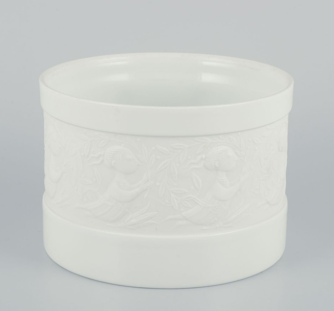 Bjorn Wiinblad for Rosenthal Studio Line. Flower pot in white porcelain. Motif of woman and flowers.: Bjorn Wiinblad for Rosenthal. Studio Line. Flower pot jar in white porcelain. Motif of woman and flowers. 1980s. Marked. Perfect condition. Dimensions: Diameter 12.8 cm. x Height 9.0 cm. Reserve: $140