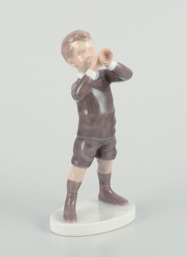 Bing and Grondahl, porcelain figurine of boy with horn. Approx. 1920s.: Bing and Grondahl, porcelain figurine of a boy with a horn. Model 1792. Approx. 1920s. Perfect condition. Marked. First factory quality. Dimensions: Height 17.0 cm. x Width 8.5 cm. Reserve: $140.00