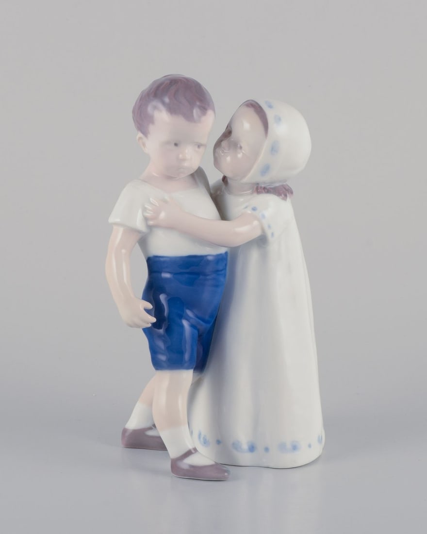 Bing & Grondahl, porcelain figurine of a little girl and boy. Approx. 1930s: Bing & Grondahl, porcelain figurine. A girl trying to kiss a boy. Designed by Ingeborg Plockross Irminger. Model number 1614. Marked. Circa 1930s. First factory quality. In perfect condition.