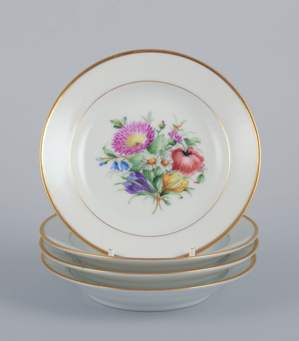 Bing & Grondahll, set of four small plates with floral motifs and gold rim. Approx. 1920s.: Bing & Grondahll, a set of four small plates hand-painted with various polychrome floral motifs and gold rim. Approximately from the 1920s. Marked. First factory quality. Perfect condition.