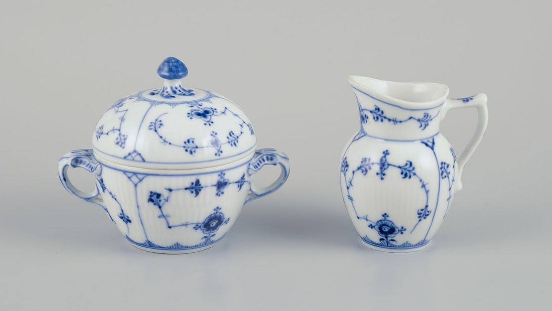 Royal Copenhagen Blue Fluted plain, creamer and sugar bowl in porcelain.: Royal Copenhagen Blue Fluted plain, creamer and sugar bowl. Approximately 1930. Model number: 1/60. Model number: 1/244. First factory quality. Lid: Third factory quality. Perfect condition. Creamer: