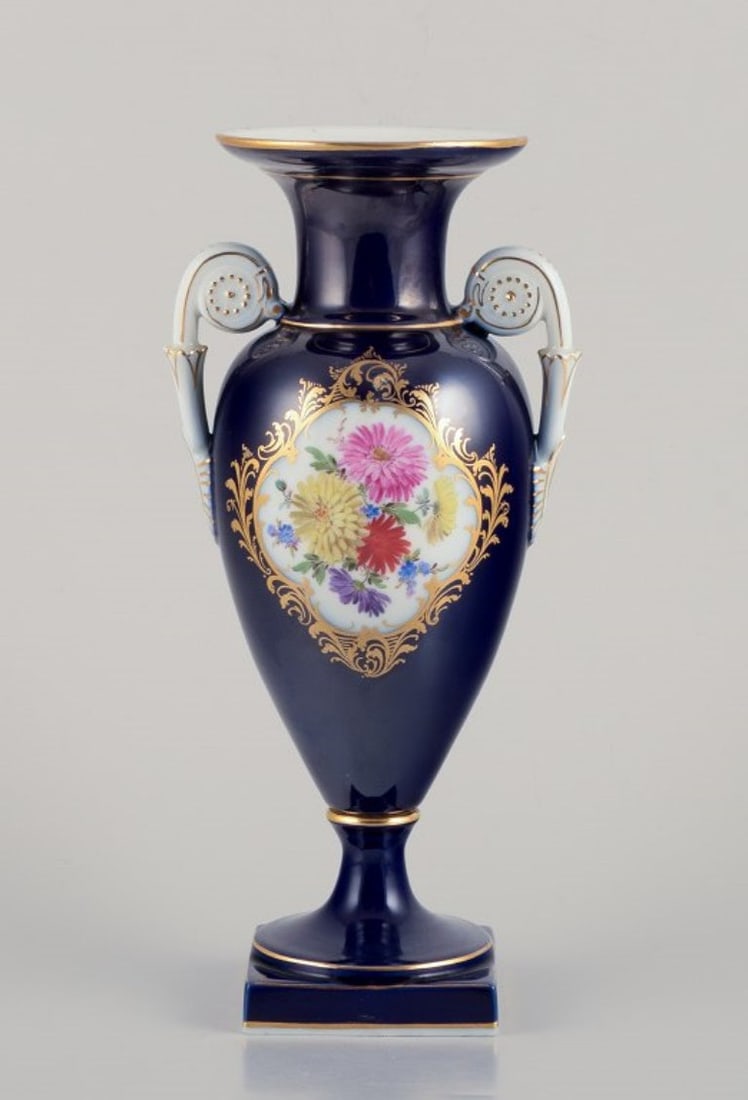 Meissen, Germany. Porcelain vase in Sevres Bleu. Approx. 1920s/30s: Meissen, Germany. Porcelain vase in Sevres Bleu. Polychrome flower motifs.Hand-painted. Gold decoration. Amphora shape with handles. Approximately from the 1920s/30s. Marked. Perfect condition. First 