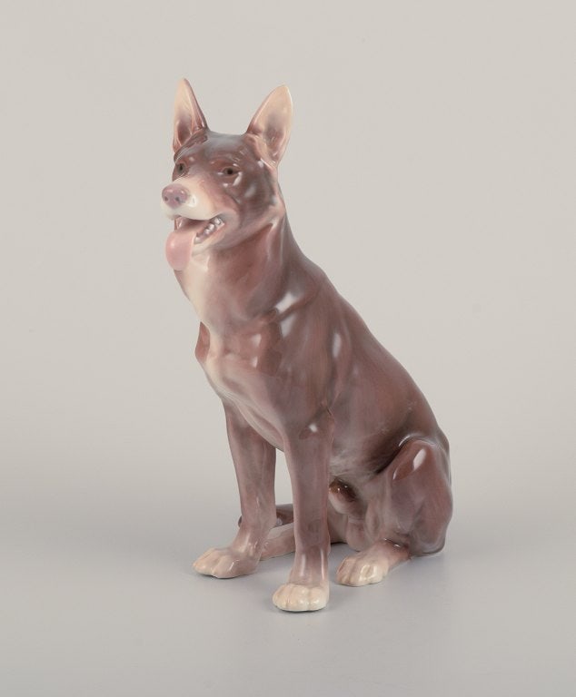 Bing & Grondahll porcelain figurine of a standing German Shepherd.: Bing & Grondahll porcelain figurine of a standing German Shepherd. Model number 1765. Designed by Laurits Jensen. 1930s. Marked. First factory quality. Perfect condition. Dimensions: H 22.0 cm x L