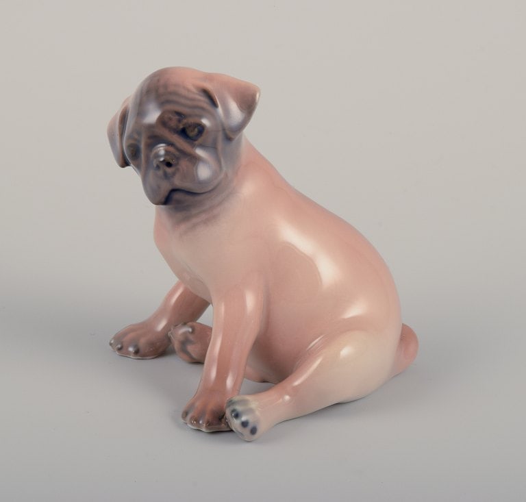 Royal Copenhagen, porcelain figurine of a Boxer puppy.: Royal Copenhagen, porcelain figurine of a Boxer puppy. Model 3169. Approximately from 1930. Marked. First factory quality. Perfect condition. Dimensions: H 7.5 cm x L 8.0 cm. Reserve: $140.00