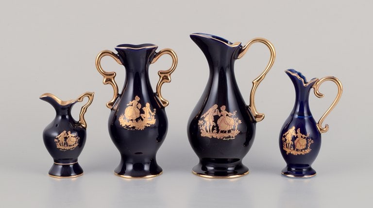 Limoges, France. Three pitchers and a vase in porcelain decorated with 22-karat gold leaf. Beautiful: Limoges, France. Three pitchers and a vase in porcelain decorated with 22-karat gold leaf. Beautiful royal blue glaze. Sceƒe¨ne galante. Approximately from 1970. Provenance: From a large French