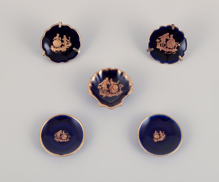 Limoges, France. Five small pieces of porcelain decorated with 22-karat gold leaf. Beautiful royal: Limoges, France. Five small pieces of porcelain decorated with 22-karat gold leaf. Beautiful royal blue glaze. Sceƒe¨ne galante. Approximately 1970. Provenance: From a large French private