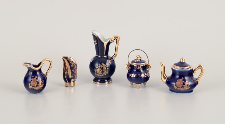 Limoges, France. Five pieces of miniature porcelain decorated with 22-karat gold leaf and beautiful: Limoges, France. Five pieces of miniature porcelain decorated with 22-karat gold leaf and beautiful royal blue glaze. Sceƒe¨ne galante. Approximately 1970. Provenance: From a large French private