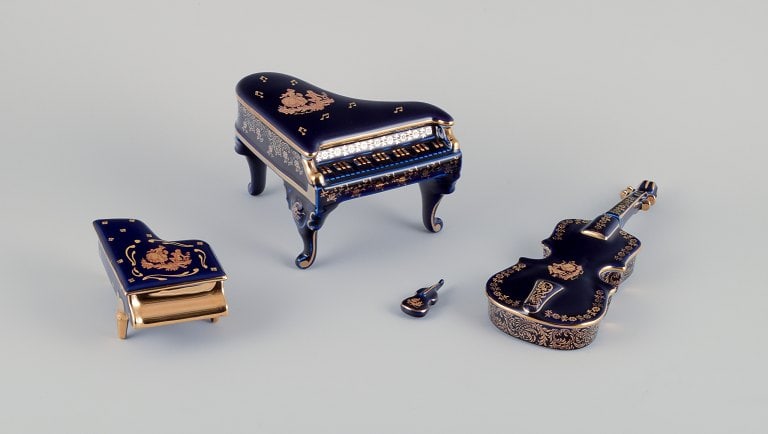 Limoges, France. Four porcelain musical instruments decorated with 22-karat gold leaf and beautiful: Limoges, France. Four porcelain musical instruments decorated with 22-karat gold leaf and beautiful royal blue glaze. Sceƒe¨ne galante. Approximately 1970. Provenance: From a large French private co