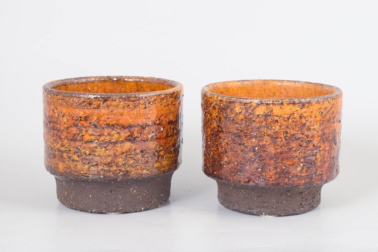 Hegnetslund, Scandinavia. Set of two cylindrical stoneware plant pots in orange and brown tones. (1 of 4)