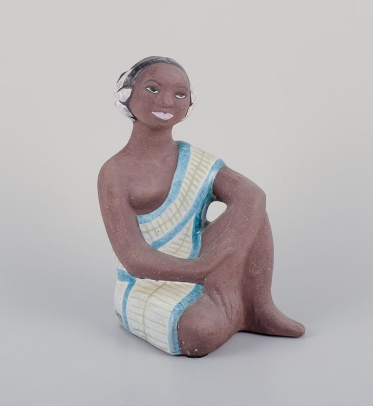 Mari Simmulson, for Upsala-Ekeby, Sweden. Rare ceramic figurine of a half-naked Tahitian woman.: Mari Simmulson (1911-2000), for Upsala-Ekeby, Sweden. Rare ceramic figurine of a half-naked Tahitian woman. Approximately 1960. Perfect condition. Marked. Dimensions: H 17.0 cm x D 9.0 cm. Mari