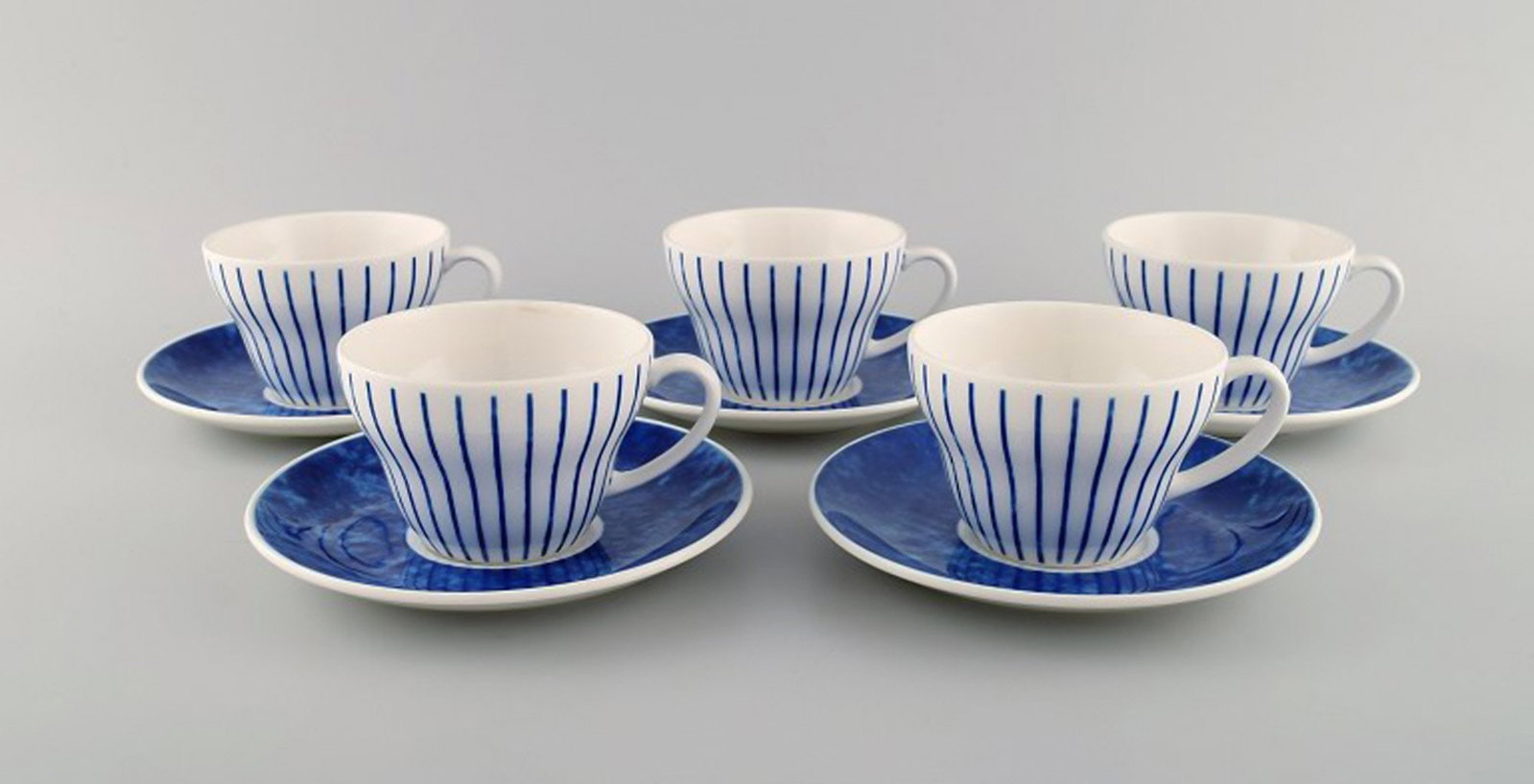 Jackie Lynd for Duka. Five Blues teacups with saucers in glazed ceramics with blue decoration.: Jackie Lynd for Duka. Five Blues teacups with saucers in glazed ceramics with blue decoration. Swedish design, early 21st century. The cup measures: 9 x 6.2 cm. Saucer diameter: 14.7 cm. in excellent 
