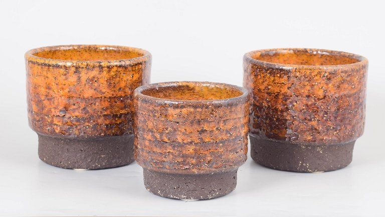 Hegnetslund, Scandinavia. Set of three stoneware plant pots in orange and brown tones. Approx. (1 of 4)