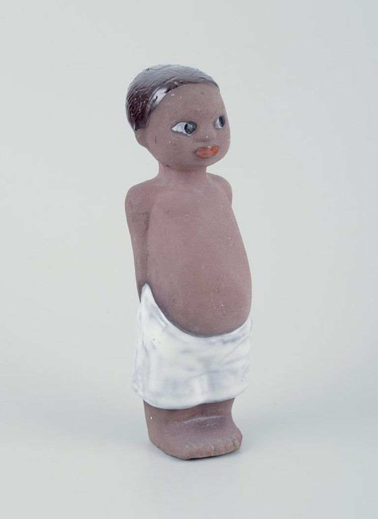 Mari Simmulson for Upsala Ekeby, Sweden. Figure of a child in glazed stoneware. Ca. 1960.: Mari Simmulson for Upsala Ekeby. Figure of a child. Glazed stoneware. Handmade. Model: 6029M Ca. 1960. Marked. Perfect condition. Dimensions: H 18,0 cm. x W 5,0 cm. Mari Simmulson (1911-2000) was an E