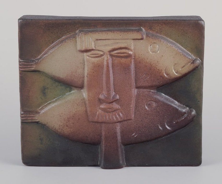 Ake Holm, Swedish ceramist. Own studio. Unique wall relief in terracotta. 1960s/70s.: Ake Holm, Swedish ceramist. Own studio. Unique wall relief in terracotta. Motif of two fish and a man's face. Glaze in green-brown tones. 1960s/70s. in excellent condition with minor and insignificant