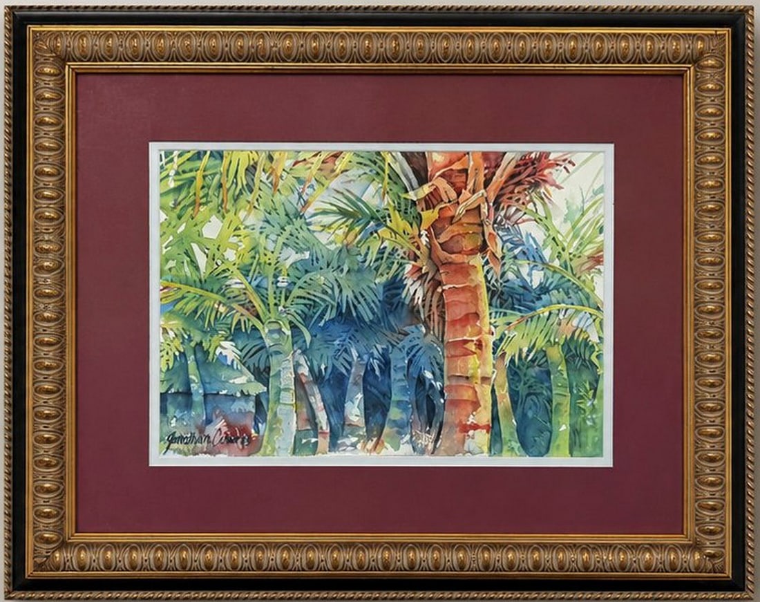 Jonathan Cederberg Framed Tropical Landscape Watercolor: A watercolor painting by Jonathan Cederberg depicting a vibrant tropical landscape with palm trees and lush foliage. The artwork is presented in a traditional gold-tone frame with a decorative