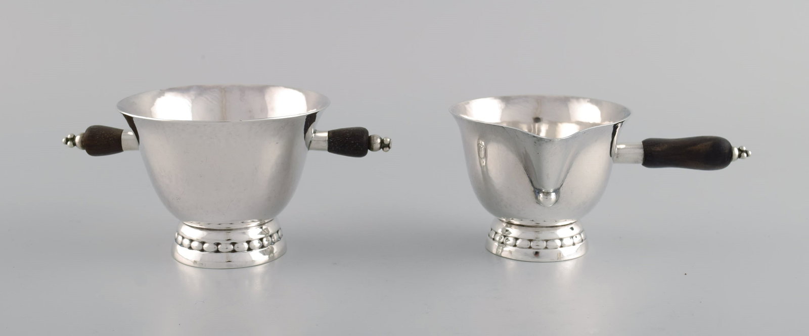 Early Georg Jensen sugar / cream set in sterling silver with handles in ebony. Dated 1915-1930.: Title:Early Georg Jensen sugar / cream set in sterling silver with handles in ebony. Dated 1915-1930. Description:Early Georg Jensen sugar / cream set in sterling silver with handles in ebony. Dated 1