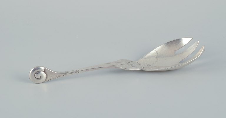 Early and rare Georg Jensen "Ornamental" pattern serving-fork chased with foliage and with a spiral: Title:Early and rare Georg Jensen "Ornamental" pattern serving-fork chased with foliage and with a spiral shell finial. Sterling silver. Description:Early and rare Georg Jensen "Ornamental" pattern se