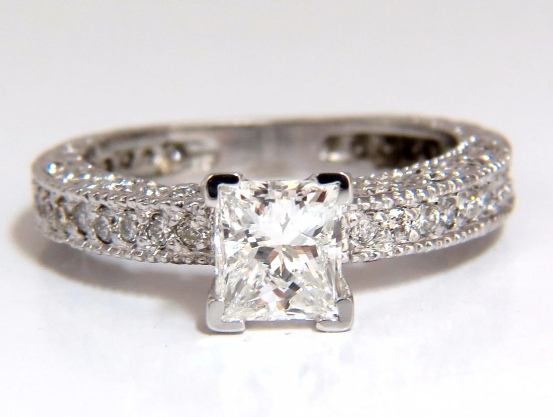 1.01ct Natural Princess cut diamond ring 14kt: Title: 1.01ct Natural Princess cut diamond ring 14kt Description: MAGNIFICENT JEWELS Princess & Rounds 1.01ct. Natural Princess brilliant diamond H-color, Si-1 clarity. 5.9 X 5.2 mm Side diamonds: .20