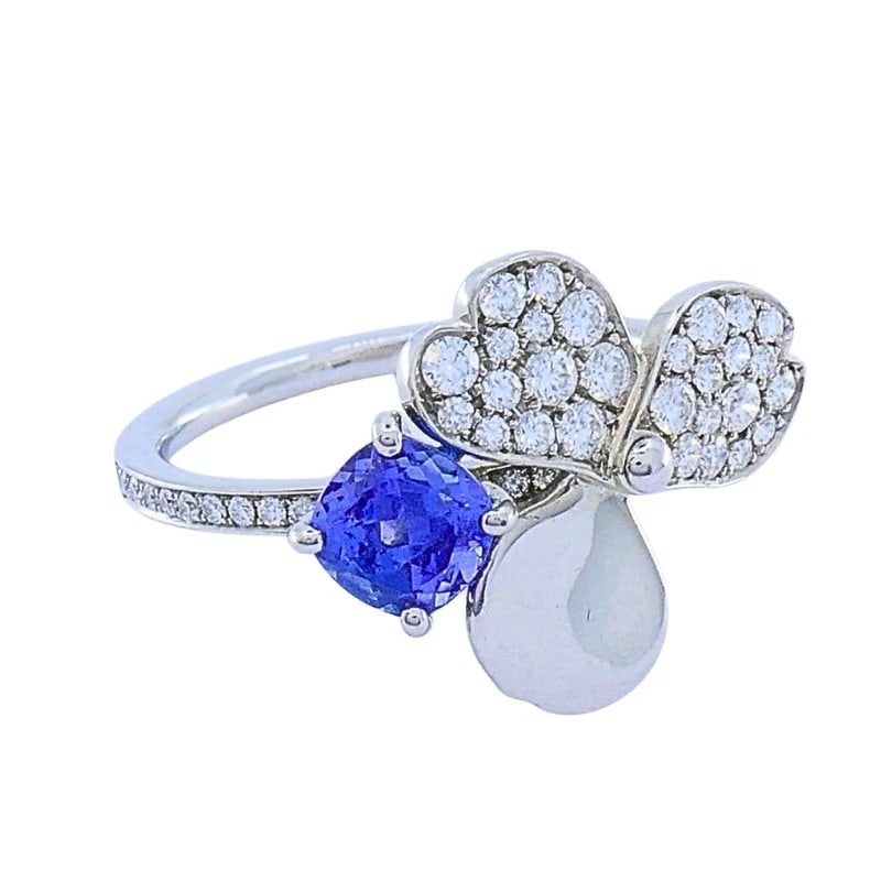 Tiffany & Co. Platinum Paper Flower Ring Tanzanite Diamonds: ES UEOO Product details: DESIGNER: Tiffany & Co. MATERIALS: Platinum 950 GEMSTONE: Diamond, Tanzanite WEIGHT: 4.9 Grams MEASUREMENTS: 11/16" x 9/16" RING SIZE: 6 - 6.25 HALLMARKS: Tiffany & Co., PT 95