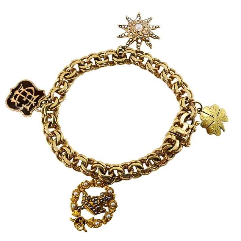 Victorian 14k Gold Link Bracelet Enamel Pearl & Engraved Charms: ES UTOO Product details: MATERIALS: 14k Gold GEMSTONE: Pearl WEIGHT: 33.1 Grams MEASUREMENTS: 1/4” x 7" Charms - 3/4" HALLMARKS: 14K, 1900 ITEM DETAILS: Victorian 14k Gold Link Bracelet Enamel