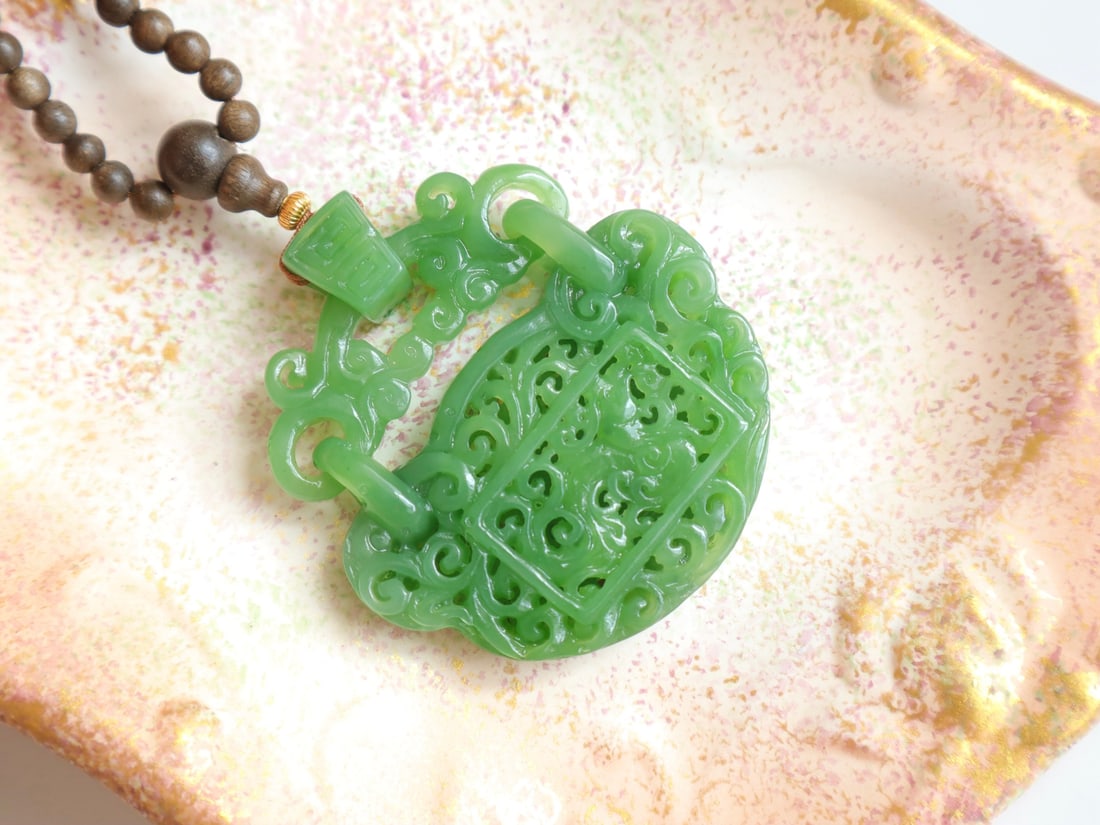Natural Green Hetian Jade Ruyi Lock Pendant: Title: Old Hetian Jade Dragon Pendant Date/Period: After2002 Origin: Chinese Dimension: 59x80x25(mm) 2.32x3.15x0.98(inches) Weight 0.35 lbs/157g Materials: Hetian Jade Reserve: $699.00 Shipping: Domes