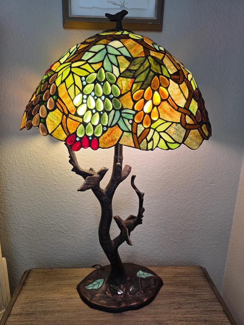 32.5" Stained Glass Oval Fruit Grapes Table Lamp: 32.5" Tall x 20" wide oval shape shade Tiffany-Style Oval Stained Glass Table Lamp Birds on Branch Base (32.5" Tall) This new reproduction Tiffany-style lamp features a pair of birds perched on a