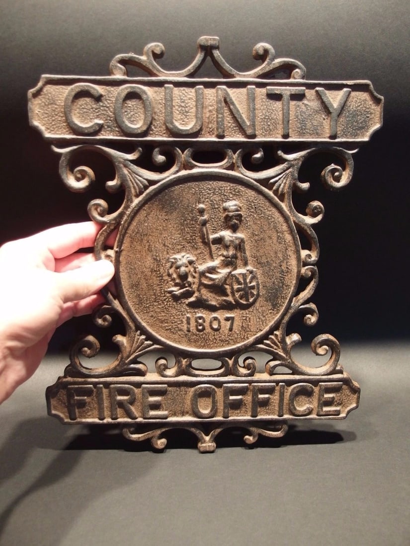 Heavy Cast Iron County Fire Office Sign 1807 Fireman: 13 1/4" Tall x 10 5/8" Wide Well made reproduction cast iron "County Fire Office" sign. Wonderful detail on this heavy sign. This sign is all cast in iron. Be sure to see the images It has great scrol