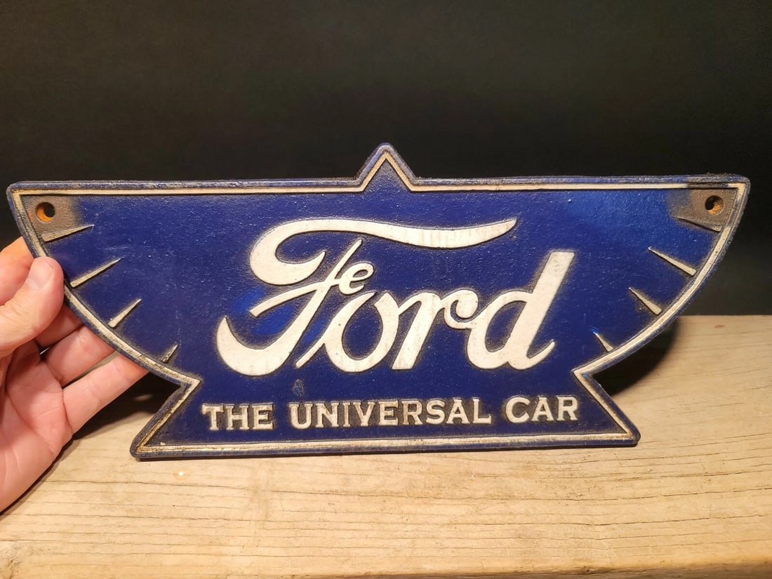 Cast Iron Ford Car Sign Plaque: 15" wide x 6 1/2" tall Wonderful reproduction Ford plaque or sign. Good detail cast iron hand painted and slightly aged to look like an antique. Certainly hard to tell its age. Reserve: $50.00 Shippin