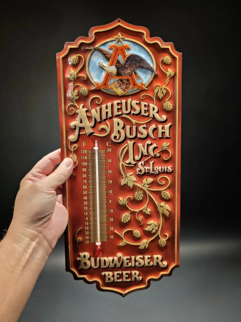 Anheuser Busch Budweiser Wall Thermometer Sign: 17.5 Vintage-Style Anheuser-Busch Budweiser Wall Thermometer Bring a taste of St. Louis home. This ornate wall thermometer features classic Anheuser-Busch branding, including the iconic "A" and Eagle