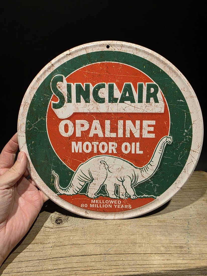 Round Metal Sinclair Sign Motor Oil Plaque: 11 1/2" wide round Wonderful reproduction plaque or sign. Good detail metal and slightly aged to look like an antique. Reserve: $15.00 Shipping: Domestic: Flat-rate of $8.00 to anywhere within the
