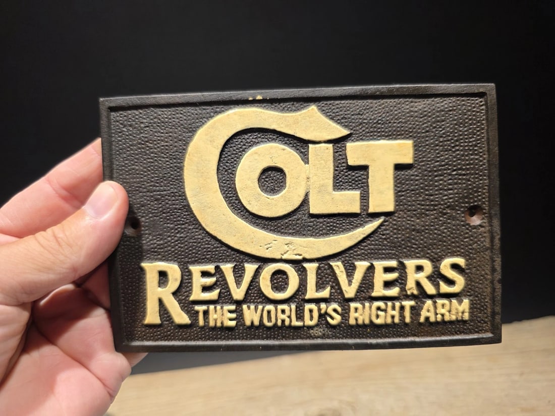 6 1/4" Cast Iron Colt Plaque Sign: 6 1/4" Long x 4 1/8" Wonderful reproduction Colt firearms plaque. Good detail solid cast iron. Hand aged to look like an antique. Certainly hard to tell its age. 100% Customer Satisfaction Guarantee
