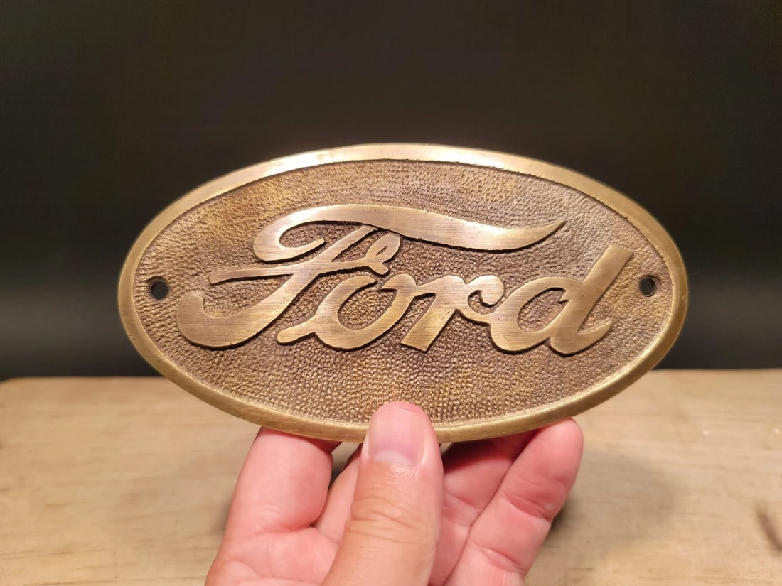 Brass Ford Plaque: 6 1/4" wide x 3 1/4" tall Wonderful reproduction Ford plaque. Good detail cast brass hand aged to look like an antique. Certainly hard to tell its age. Reserve: $28.00 Shipping: Domestic: Flat-rate