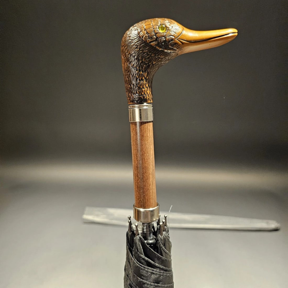 Mallard Head Umbrella: This Italian handcrafted mallard head umbrella features a sturdy mallard handle and a black canopy on a self-opening 25 x 8 frame, with a sheath for convenient storage. Built to last. The item in the
