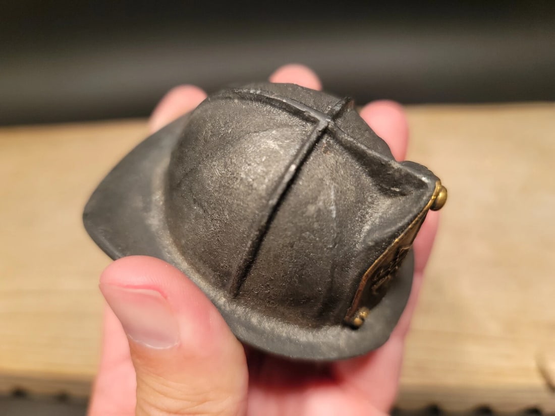 Miniature Cast Iron Fireman Helmet Bottle Opener: 3 1/8" Long x 2 1/2" Wide Such a neat reproduction antique fire helmet. This wonderful helmet was cast from an antique and made to actually look old via slight distressing. Notice the bottom has a slo