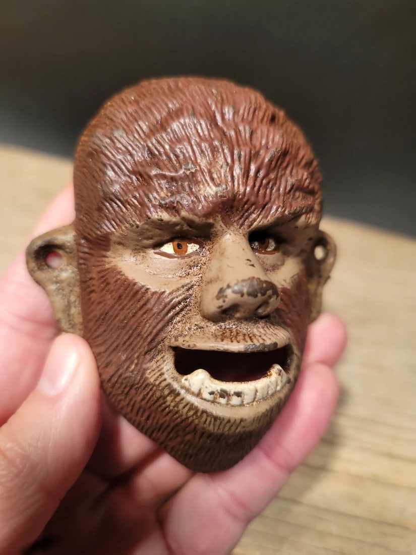 Cast Iron folk art Wolf Man Wall mount Bottle Opener: 3 3/4" Tall x 3 1/4" Wide Great reproduction cast iron bottle opener. This piece was made to look just like an antique, but is new. Reserve: $18.00 Shipping: Domestic: Flat-rate of $9.00 to anywhere w