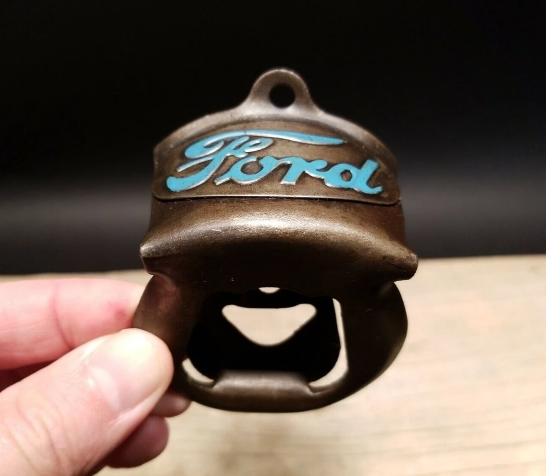 Ford Beer Bottle Cap Opener: 3 1/4" tall x 2 3/8" wide Wonderful Ford motors wall mount bottle cap opener. Well made all metal opener comes with mounting screws! Reserve: $20.00 Shipping: Domestic: Flat-rate of $8.00 to anywhere