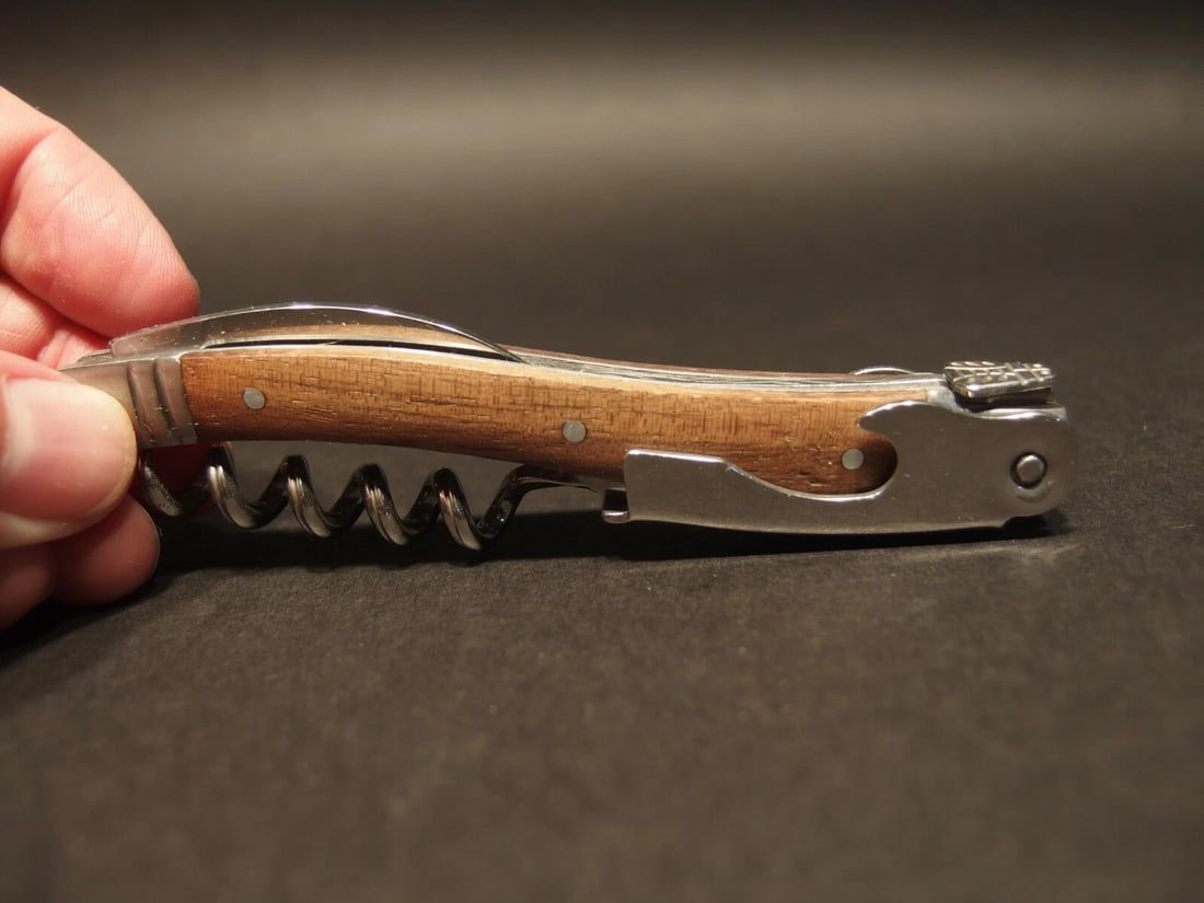 Laguiole Corkscrew with Walnut Wood Handles: 4 1/2" long x 5/8" Wide Nice quality, brand new, never used heavy waiters style Laguiole corkscrew with walnut wood handles. This piece is made from stainless steel with a ribbed corkscrew worm and
