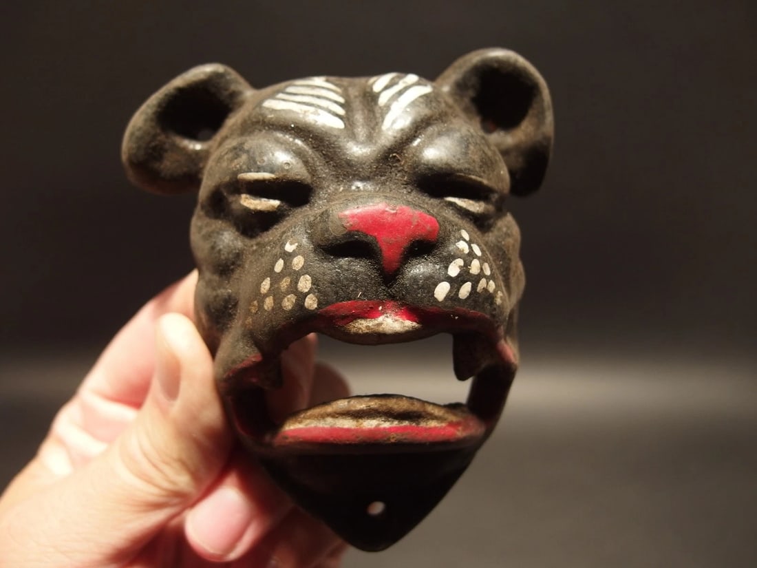 Cast Iron wall mount folk art Bulldog Beer Bottle Opener: 4" Tall x 3 1/2" Wide Such a neat reproduction antique cast iron bulldog wall mounted bottle cap opener. The mouth of the bulldog is where you would open the bottle. Certainly a great accent piece!