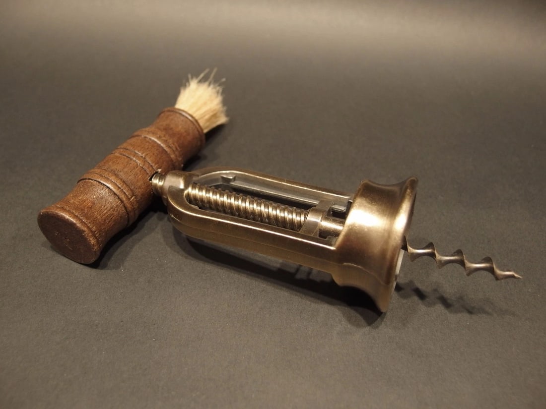 Open Frame Corkscrew w Brush Wine Bottle Opener: 6 1/4" Long max x 4 1/2" Wide Antique reproduction open frame mechanical bristle brush corkscrew. The handle is hardwood, the shaft and worm are steel. The frame is likely cast brass or zinc due to