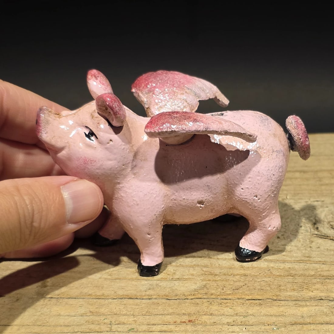 4" Cast Iron Flying Pig Coin Bank: Gemini said Reproduction Cast iron coin bank in the form of a winged flying pig, a whimsical novelty design inspired by early figural banks and folk art humor. Animal-form banks became especially