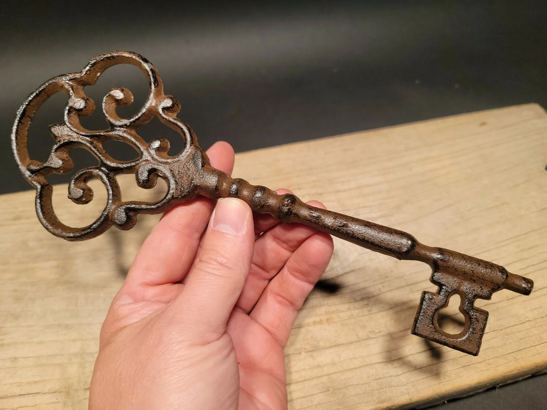Cast Iron Large Ornate Skeleton Key: 9 1/2" Long 3 1/2" Wide Such a wonderful reproduction antique cast iron key! As you can see this key has a somewhat ornate shape. The entire piece is cast iron in a antique gun metal gray finish. Rese