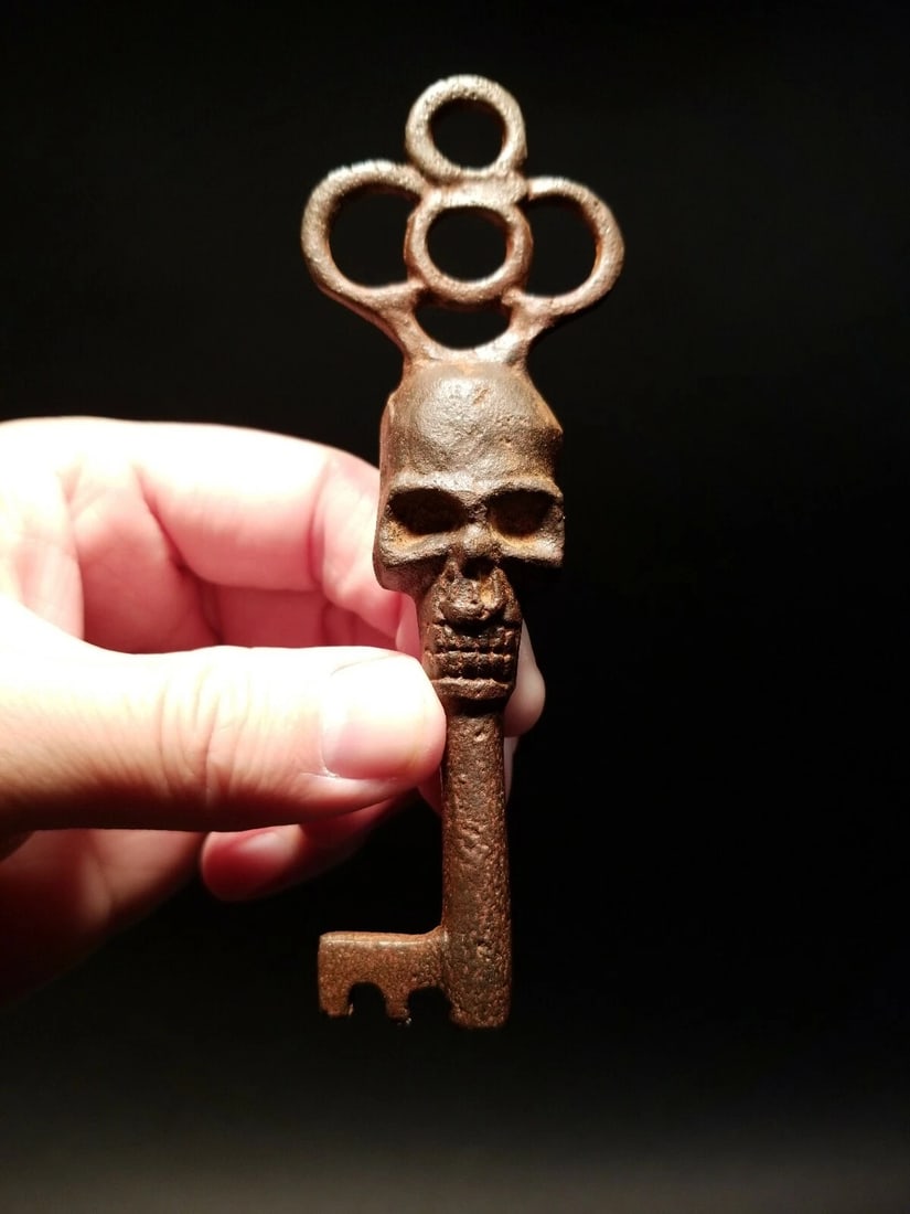 Cast Iron Skull Skeleton Key: 4 3/4" long x 1 5/8" wide Great large reproduction cast iron key! The key is a a natural brown rust color. Nice heavy solid quality. Notice the in the center of the key handle. Such a nice piece! Can