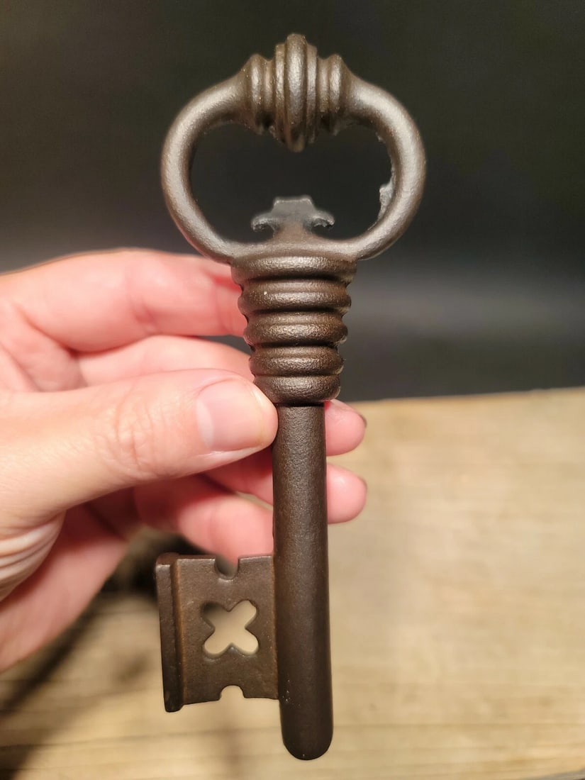 6 1/8" Antique Style Iron Large Skeleton Key: 6 1/8" x 2 1/8" Great large reproduction cast iron key! The key is a brown black rust color. Nice heavy solid quality. Large format keys such as this were commonly paired with large door and gate
