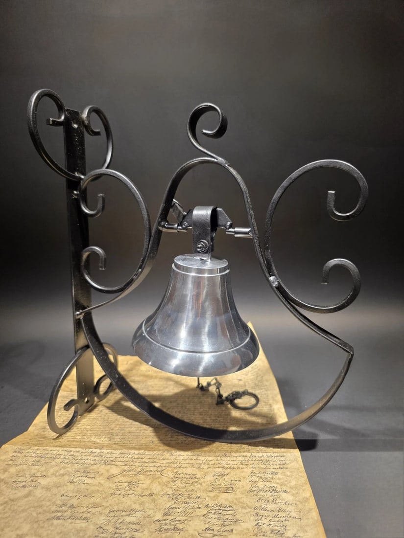 Wrought Iron Scrollwork Wall Mounted Garden/Home Bell: 14" Tall 12" Extension Wrought Iron Scrollwork Dinner Bell - Wall Mounted Garden/Home Bell This is a functional wall-mounted dinner bell featuring a polished silver-tone bell suspended within a black