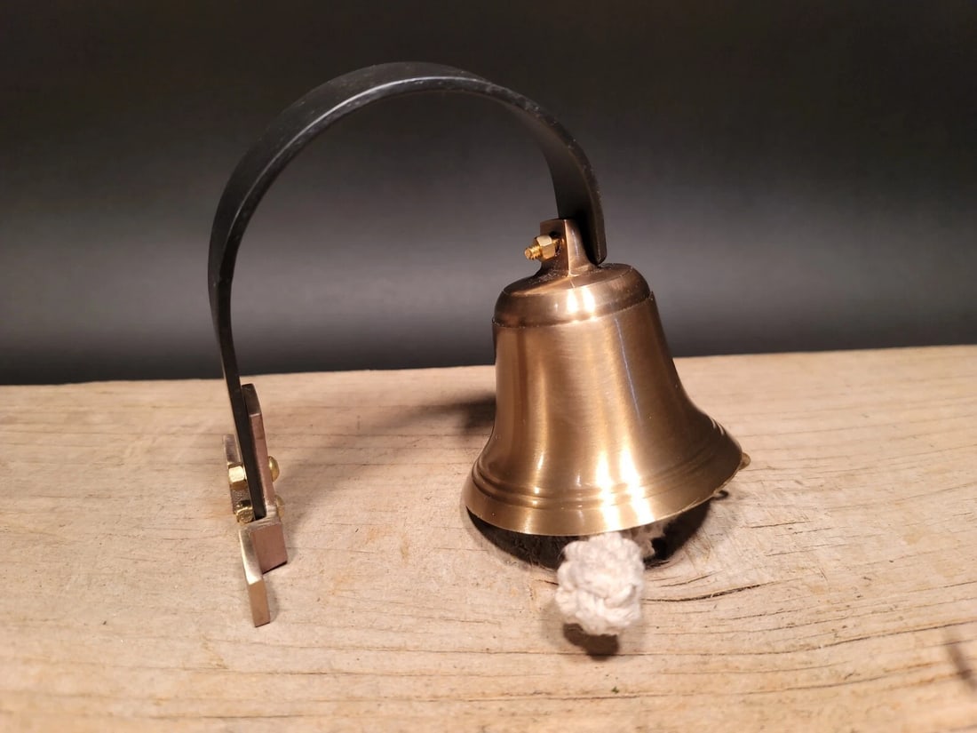 Brass Wall Mount Dog Doorbell Bar Bell: 5 1/2" Extension 3" wide 4 1/2" overall height Such a neat reproduction antique bell. The bell swivels left and right. Great tight knot hanging from the clapper. All brass, has a wonderful resonating