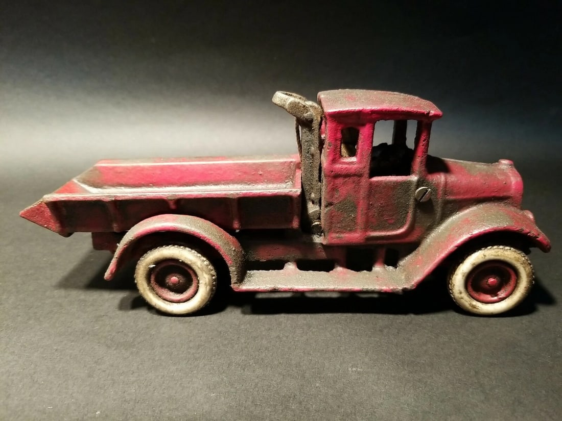 Cast Iron Red Dump Truck Flat bed Car Rubber Wheels: 10 1/4" Long x 3 1/4" Wide 4 1/8" Tall Such a neat reproduction cast iron tow truck! As you can see this heavy cast iron truck was wonderfully hand painted and distressed to look original. The car is