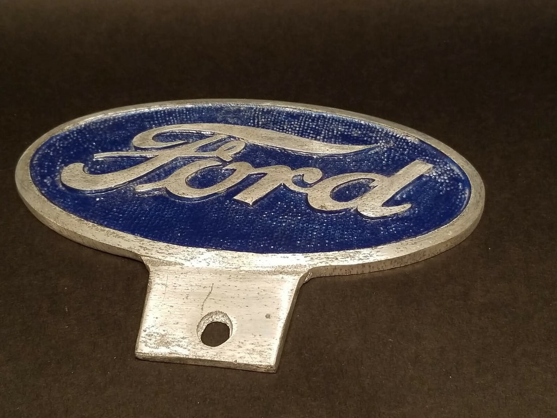 Cast Aluminum Ford Car License Plate Fob Topper: 6 1/2" wide x 4 3/4" tall Wonderful reproduction Ford license plate topper. Good detail cast aluminum hand painted and slightly aged to look like an antique. Certainly hard to tell its age. Reserve: